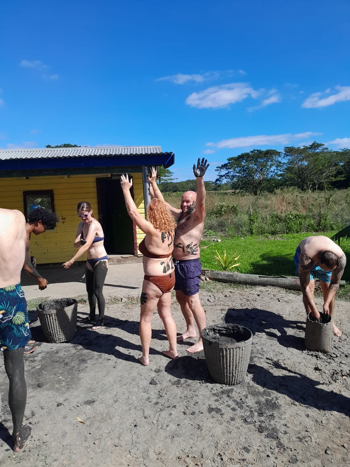 Guests covering each other in mud at the Sabeto mud pool